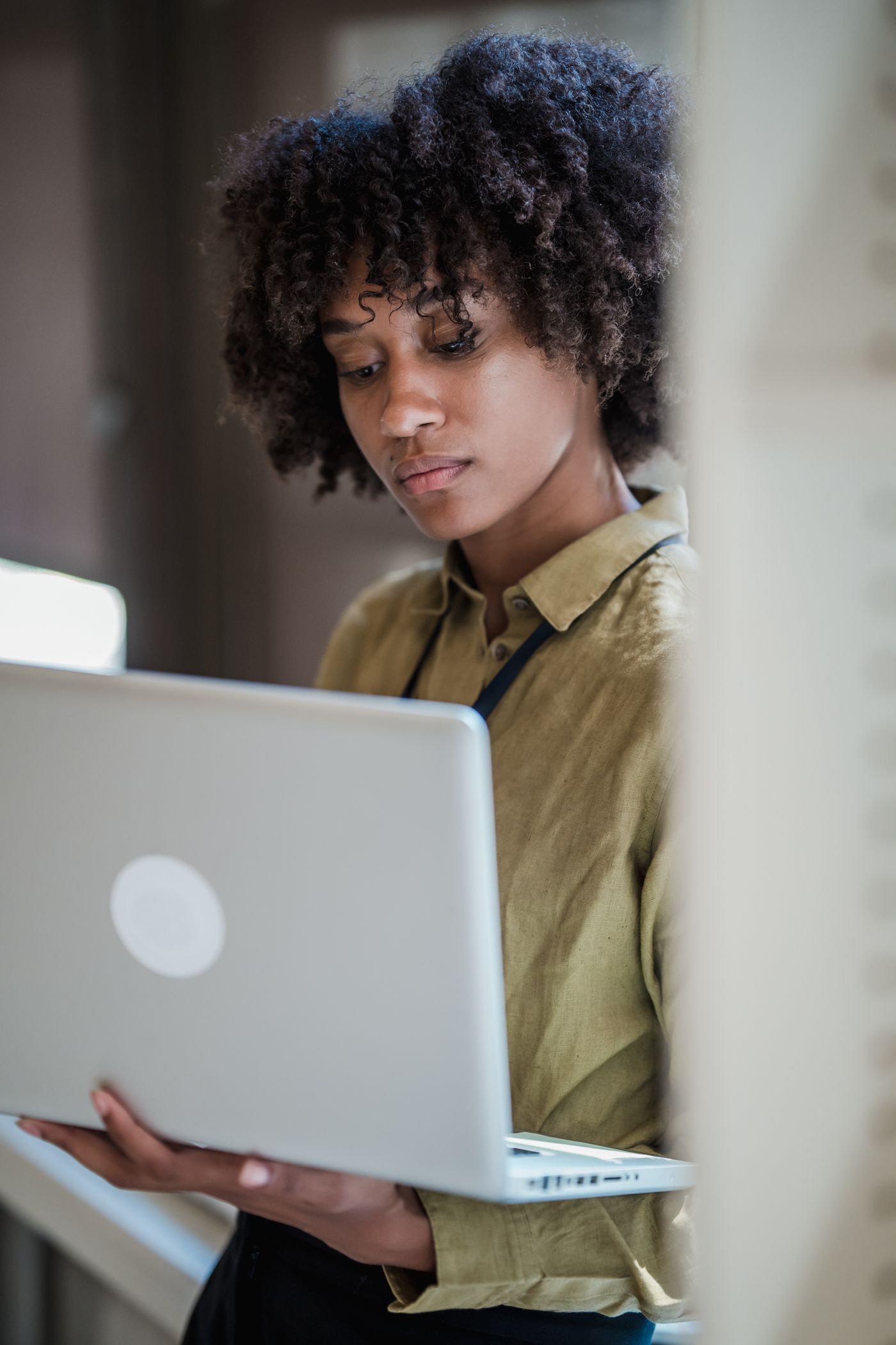 A professional reviewing work on a laptop