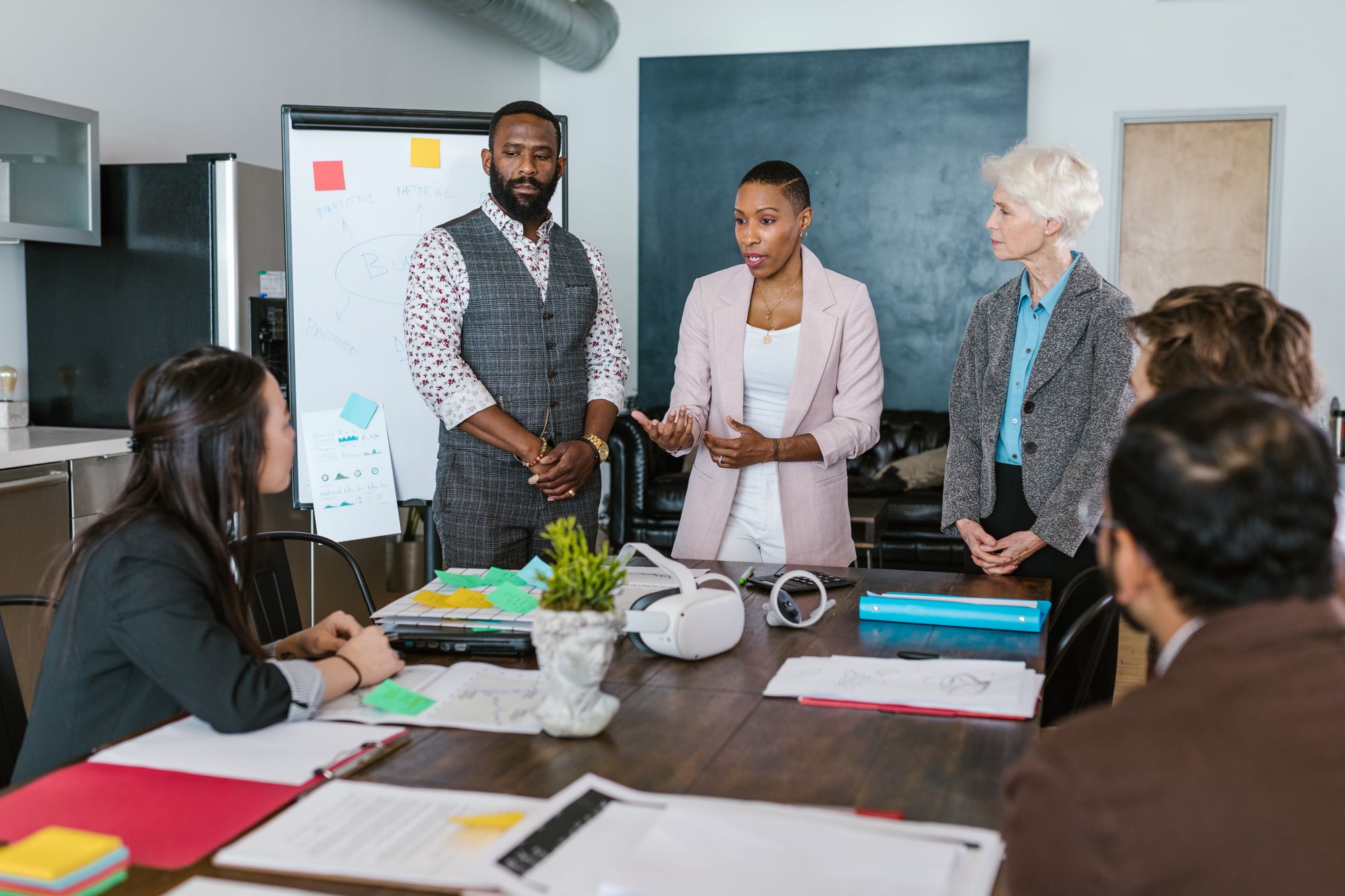 A team lead presenting a plan to colleagues around a meeting table